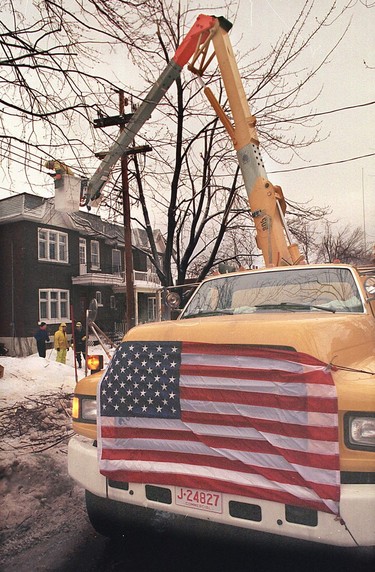 Workers from the Connecticut Light and Power Company lend a hand on Oxford Ave. in N.D.G. on Jan. 13, 1998.