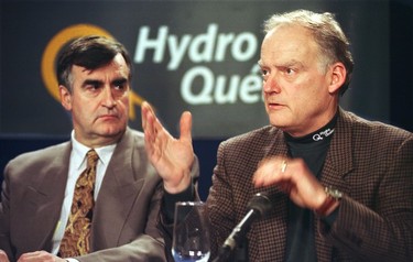 Hydro-Québec head André Caillé addresses reporters under the watchful eyes of Premier Lucien Bouchard on Jan. 15, 1998.