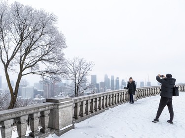 Vancouverites John Wang and his wife Amy Wang grab a souvenir photo at the chalet atop Mount Royal on Thursday, Jan. 5, 2023, before moving on to Quebec City.