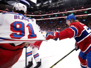 Canadiens left wing Michael Pezzetta (55) gives New York Rangers left wing Sammy Blais (91) a tug of the jersey during NHL action in Montreal, on Thursday, Jan. 5, 2023.