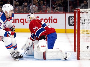 New York Rangers left wing Artemi Panarin (10) slips the puck past Montreal Canadiens goaltender Jake Allen (34) during NHL action in Montreal, on Thursday, Jan. 5, 2023.