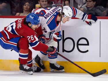 Canadiens defenceman Johnathan Kovacevic (26) and New York Rangers right wing Vitali Kravtsov (74) battle for the puck during NHL action in Montreal, on Thursday, Jan. 5, 2023.