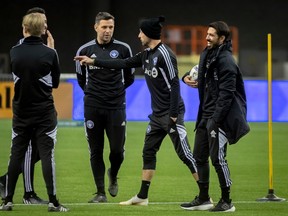 CF Montréal head coach Hernán Losada, far right, shares a laugh with members of the staff during Day 1 of training camp at Olympic Stadium in Montreal on Jan. 9, 2023.