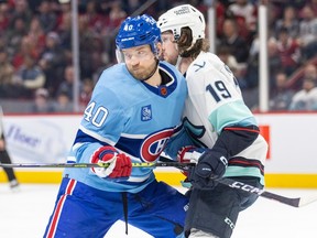 Montreal Canadiens Joel Armia leans into Seattle Kraken's Jared McCann during the first period of a National Hockey League game in Montreal Monday January 9, 2023.