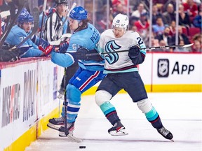 Canadiens' Michael Pezzetta is knocked off the puck by Seattle Kraken's Eili Tolvanen during third period of National Hockey League game in Montreal Monday Jan. 9, 2023.