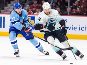 Montreal Canadiens' Josh Anderson forechecks Seattle Kraken's Jamie Oleksiak during first period in Montreal on Jan. 9, 2023.