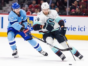 Canadiens' Josh Anderson forechecks Seattle Kraken's Jamie Oleksiak during the first period of a National Hockey League game in Montreal Monday Jan. 9, 2023.