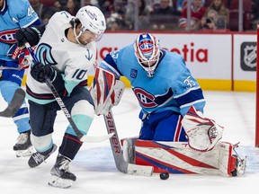 Canadiens' Sam Montembeault makes a save on Seattle Kraken's Matty Beniers during the second period of a National Hockey League game in Montreal Monday Jan. 9, 2023.