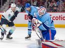 Canadiens' Sam Montembeault makes a save as Seattle Kraken's Ryan Donata and Habs' Joel Edmundson watch during the second period of a National Hockey League game in Montreal Monday Jan. 9, 2023.