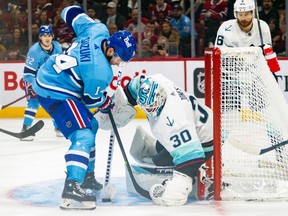 Canadiens' Nick Suzuki can't get his stick on a loose puck in front of Seattle Kraken goalie Martin Jones during the third period of a National Hockey League game in Montreal Monday Jan. 9, 2023.