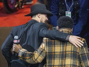 Carey Price escorts former teammate P.K. Subban off the ice after the ceremony on Thursday.