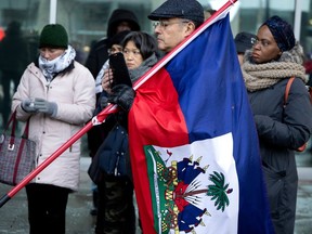 A small group gather and listen to speakers during a memorial to honour Fritznel Richard in Montreal, on Sunday, Jan. 15, 2023. Richard died trying to cross the Canadian/American border on Jan. 4.