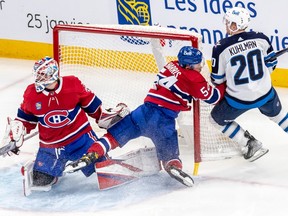 Montreal Canadiens defenceman Jordan Harris crashes into goalpost as goaltender Sam Montembeault follows puck during first period at the Bell Centre in Montreal on Jan. 17, 2023.