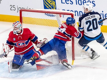 Montreal Canadiens defenceman Jordan Harris (54) collides into the goal post as Montreal Canadiens goaltender Sam Montembeault (35) watches the puck during 1st period NHL action at the Bell Centre in Montreal on Tuesday Jan. 17, 2023.