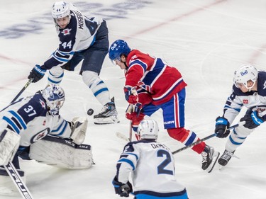 Montreal Canadiens right wing Cole Caufield (22) couldn't get his stick on the puck in front of Winnipeg Jets goaltender Connor Hellebuyck (37) during 3rd period NHL action at the Bell Centre in Montreal on Tuesday Jan. 17, 2023.