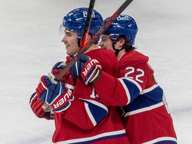 Montreal Canadiens right wing Cole Caufield (22) hugs teammate Nick Suzuki (14) after defeating the Winnipeg Jets 4-1 at the Bell Centre in Montreal on Tuesday Jan. 17, 2023.