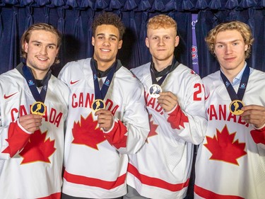 Team Canada players, left to right, Joshua Roy, left wing, Tyson Hinds, defence, Nathan Gaucher, centre, and Owen Beck, centre, with their gold medals prior to the Canadiens/Jets NHL game at the Bell Centre in Montreal on Tuesday Jan. 17, 2023.