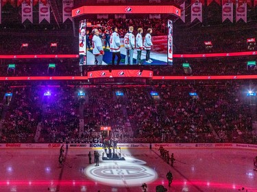 Team Canada coach Stephane Julien, left with players, left to right, Tyson Hinds, defence, Nathan Gaucher, centre, Owen Beck, centre and Joshua Roy, left wing, were celebrated for winning World Championship gold prior to the Canadiens/Jets NHL game at the Bell Centre in Montreal on Tuesday Jan. 17, 2023.