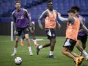 CF Montréal midfielder Victor Wanyama, center, and Joel Waterman, left, during practice at the Olympic Stadium on Jan.  18, 2023.