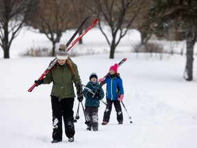 Nadia Pellecchia leads her son, Luca, and daughter, Maya, off the trails after enjoying cross-country skiing at Golf Dorval on Saturday.
