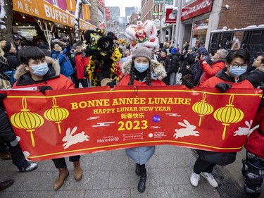 The head of the Lunar New Year parade leads the way through Montreal's Chinatown on Saturday, Jan. 21, 2023.