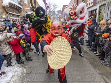 Members of the Fo Guang Shan Montreal Lion Dance and Drum Team take part in the  Lunar New Year parade in Montreal's Chinatown on Saturday, Jan. 21, 2023.