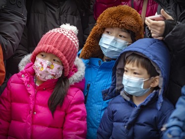 Children watch the festivities at Sun Yat-Sen Park during the Chinese New Year celebration in Montreal's Chinatown on Saturday, Jan. 21, 2023.