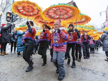 Members of the Phoenix Artistic Troupe dance in the Lunar New Year parade in Montreal's Chinatown on Saturday, Jan. 21, 2023.