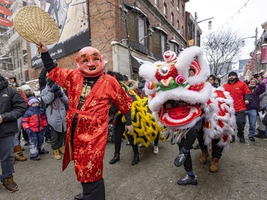 Members of the Fo Guang Shan Montreal Lion Dance and Drum Team take part in the Lunar New Year parade in Montreal's Chinatown on Saturday, Jan. 21, 2023.