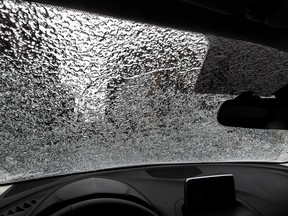 Ice from freezing rain is seen on a car windshield.