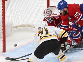 Boston Bruins' Taylor Hall (71) scores on Montreal Canadiens goaltender Sam Montembeault and David Savard (58) during second period NHL action in Montreal on Tuesday Jan. 24, 2023.