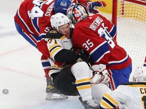 Canadiens' Jordan Harris (54) squeezes Boston Bruins' Taylor Hall (71) into Montreal Canadiens goaltender Sam Montembeault during first period NHL action in Montreal on Tuesday Jan. 24, 2023.