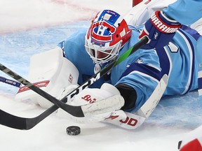 Canadiens goaltender Jake Allen sprawls to cover a loose puck during third-period action at the Bell Centre Thursday night.