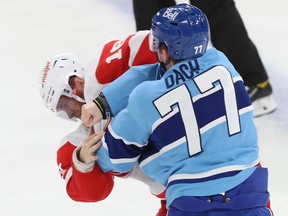 Montreal Canadiens' Kirby Dach throws a punch at Detroit Red Wings' Andrew Copp during second period in Montreal on Jan. 26, 2023.