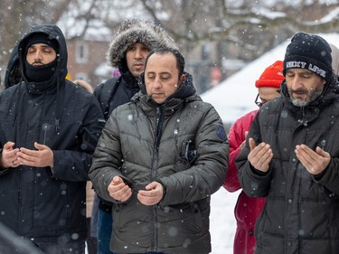Men pray during a ceremony to remember the people slain in the 2017 Quebec City mosque shooting in Verdun on Friday, Jan. 27, 2023.