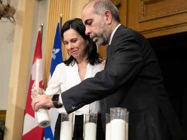 MONTREAL, QUE.: JANUARY 27, 2023 --  Samer Majzoub, president of the Canadian Muslim Foundation and Montreal mayor Valerie Plante light a candle at Montreal city hall Friday January 27, 2023, to commemorate the Quebec city mosque killings of 2017.