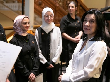 Montreal Mayor Valérie Plante, right, speaks to members of the Islamic community at city hall on Friday, Jan. 27, 2023, during a brief ceremony to commemorate the Quebec city mosque killings in 2017.