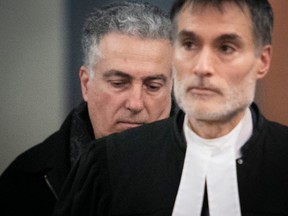 Fadi Hamdan, left, walks behind his lawyer, François Taddeo, at the Montreal courthouse on Tues., Jan. 31.