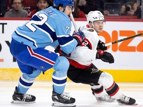 Canadiens defenceman Arber Xhekaj leans on Senators' Alex DeBrincat at the Bell Centre on Jan. 31, 2023.