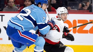 Canadiens defenceman Arber Xhekaj leans on Senators' Alex DeBrincat at the Bell Centre on Jan. 31, 2023.