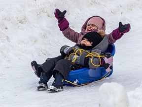 Kids took advantage of the weather to slide downhill at the Kirkland Winter Carnival at Meades Park on Saturday.