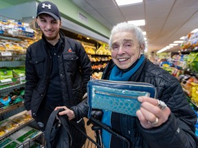 Mary Hoerig shows off the wallet found by Marché Epicure employee Ajmal Gulam in a shopping cart in the store parking lot and who then delivered it personally to her home.