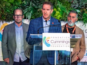 Montreal Alouettes president Mario Cecchini is flanked by general manager Danny Macocia, left, and team owner Gary Stern onstage at the 18th annual Sports Celebrity Breakfast fundraiser for the Cummings Jewish Centre for Seniors in Montreal on June 12, 2022.