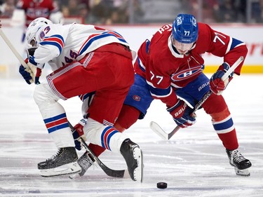 Canadiens centre Kirby Dach (77) trips up New York Rangers centre Mika Zibanejad (93) after a face-off during NHL action in Montreal, on Thursday, Jan. 5, 2023.