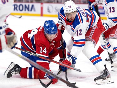 New York Rangers right wing Julien Gauthier (12) holds Montreal Canadiens centre Nick Suzuki (14) down after a face-off during NHL action in Montreal, on Thursday, Jan. 5, 2023.