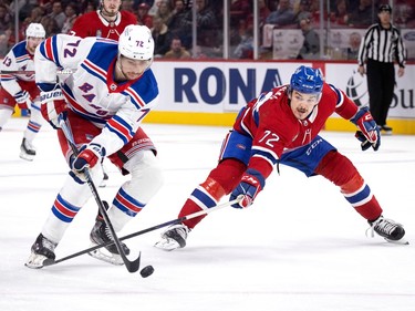 Canadiens defenceman Arber Xhekaj (72) successfully tips the puck away from New York Rangers centre Filip Chytil (72) during NHL action in Montreal, on Thursday, Jan. 5, 2023.