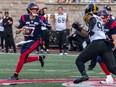 Montreal Alouettes quarterback Trevor Harris looks for downfield against the Hamilton Tiger-Cats during second half of CFL Eastern semifinal at Percival Molson Stadium in Montreal on Nov. 6, 2022.