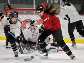 Montreal Force's Brooke Stacey, right, battles for the puck with Laura Jardin during a team practice in Montreal on Jan. 17, 2023.