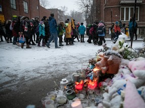 Youngsters on Dec. 16, 2022 walk past a makeshift memorial to Mariia Legenkovska, the 7-year-old Ukrainian refugee who was killed by a motorist on her way to school in Ville-Marie borough.