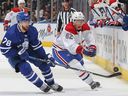 Owen Beck of the Montreal Canadiens turns the puck away against TJ Brodie of the Toronto Maple Leafs during the preseason game at Scotiabank Arena on September 28, 2022 in Toronto.